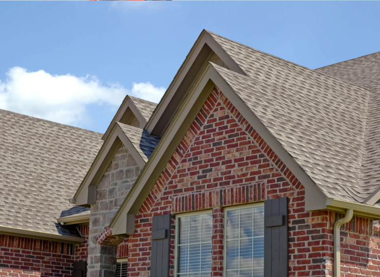 Roofer installing new dark tiles